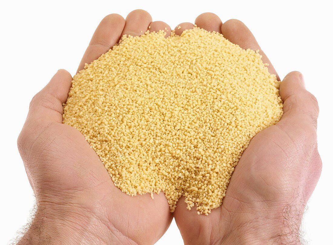 Hands holding couscous