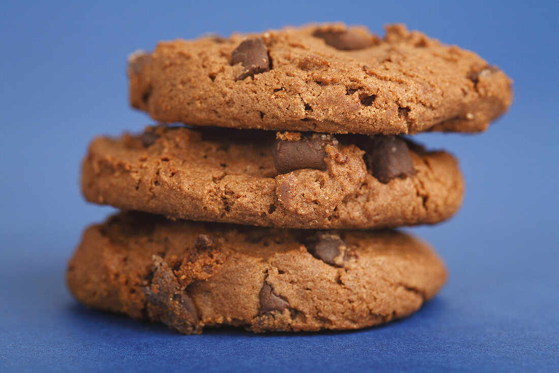 Three chocolate chip cookies in a pile