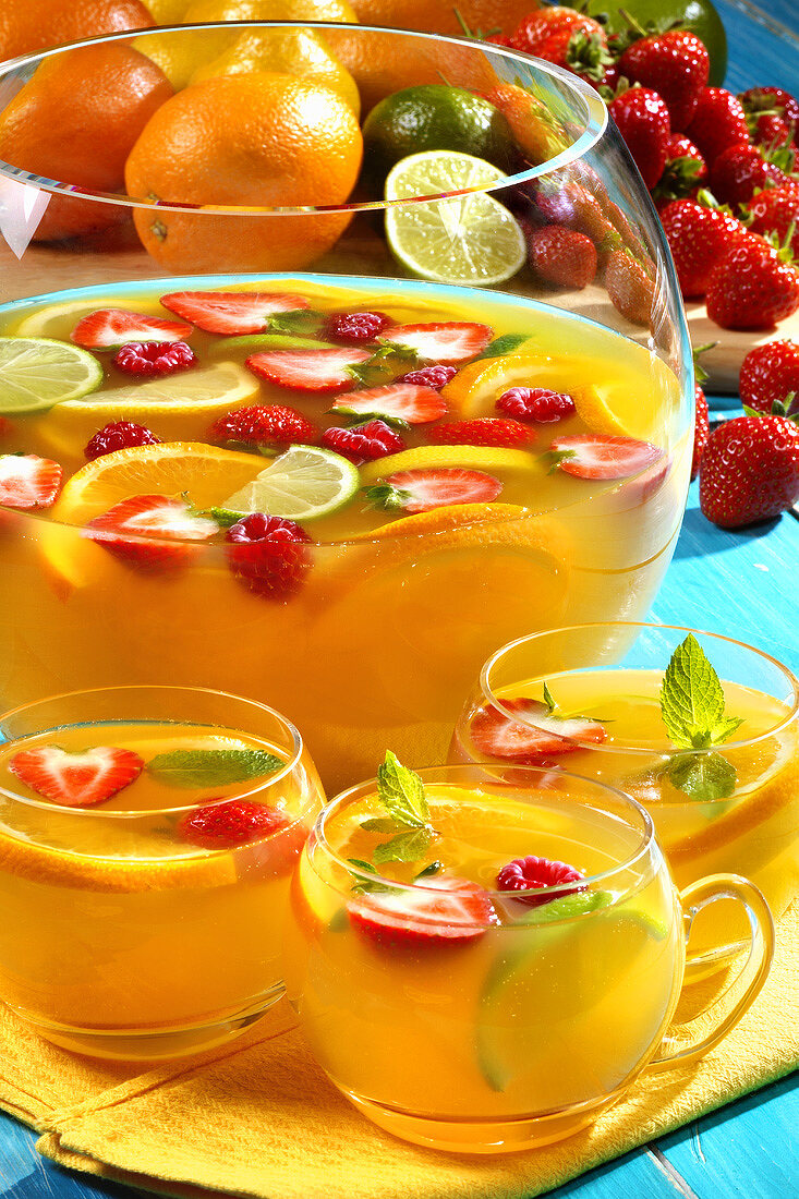 Punch with citrus fruit and berries in glass cups