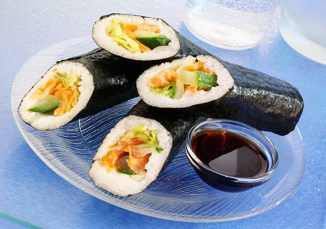 Four sushi rolls with soy sauce