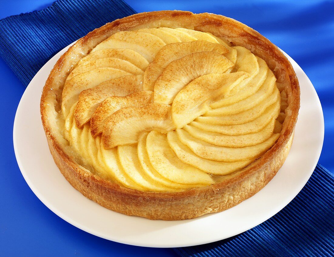 An apple tart on a cake plate