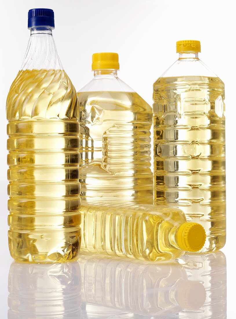 Vegetable oil in four plastic bottles