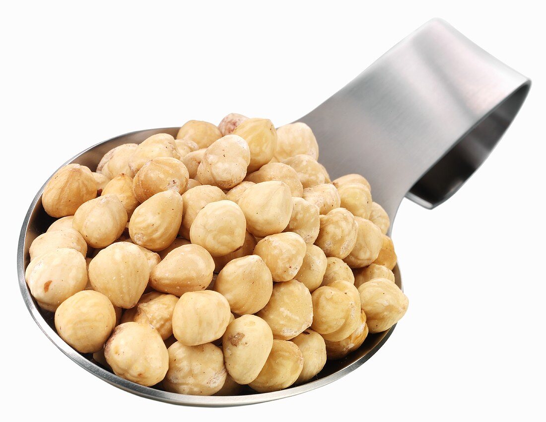 Shelled hazelnuts on a spoon