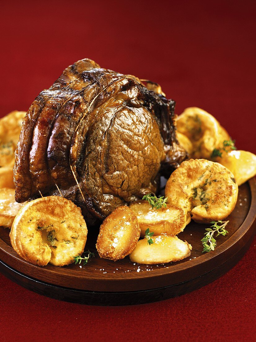 A joint of roast beef with roast potatoes