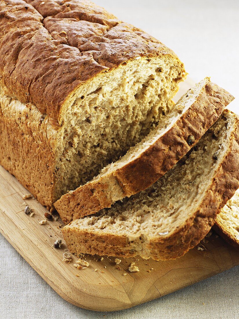 A wholemeal loaf, partly sliced