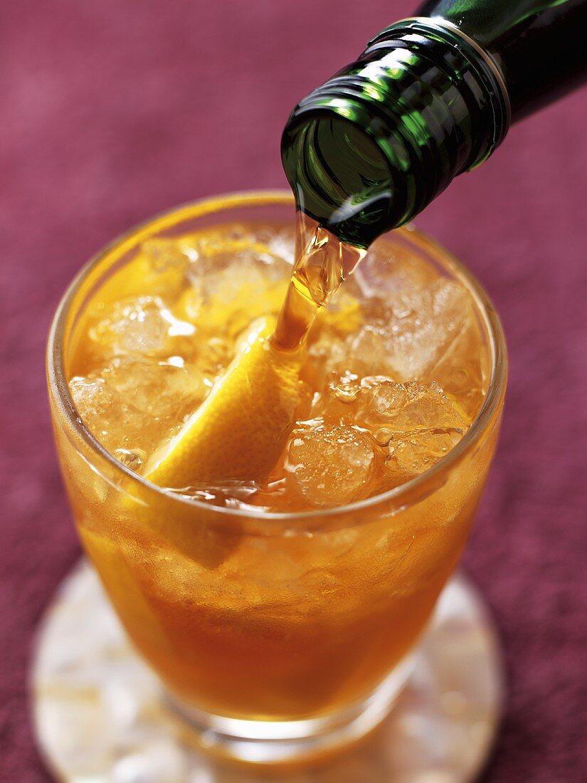 Pouring a glass of ginger wine