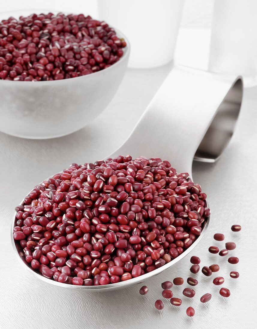 Azuki beans on a spoon and in a glass bowl