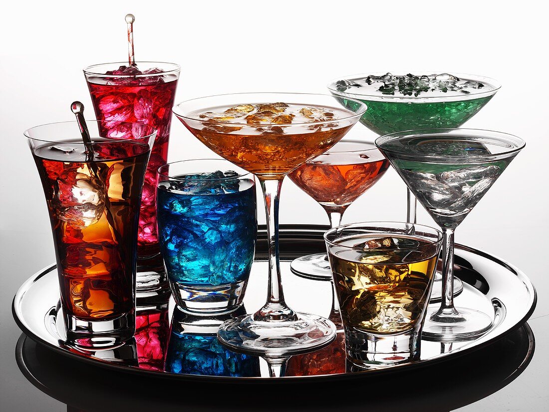 Various coloured cocktails on a tray