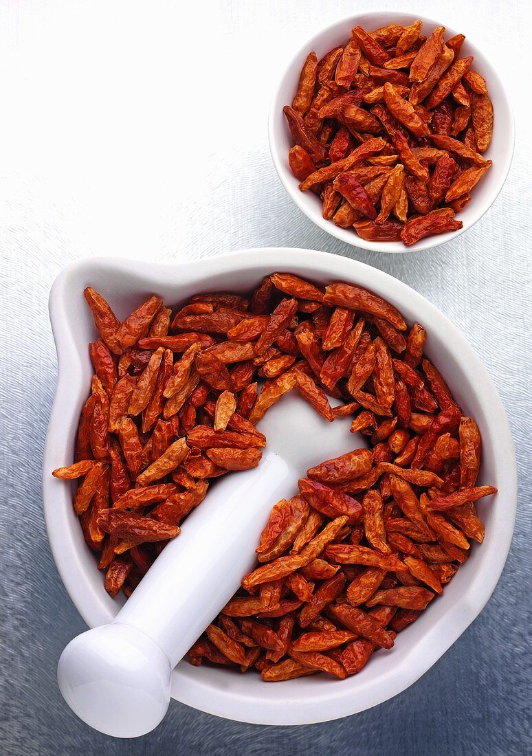 Dried chillies in a mortar and a small dish