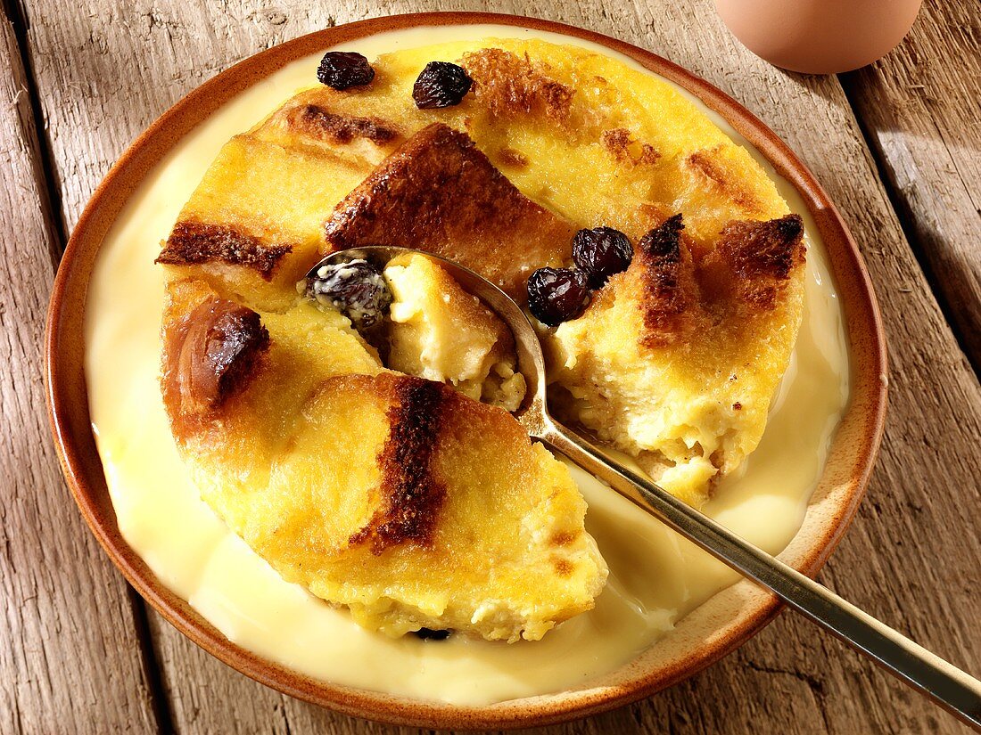 Bread and butter pudding with custard on a plate