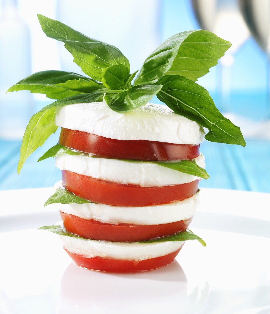 Tower of tomatoes and mozzarella with basil