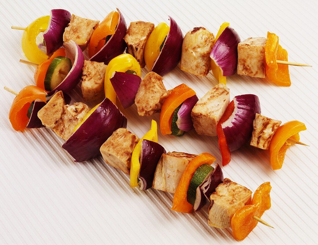 Three grilled chicken and vegetable kebabs