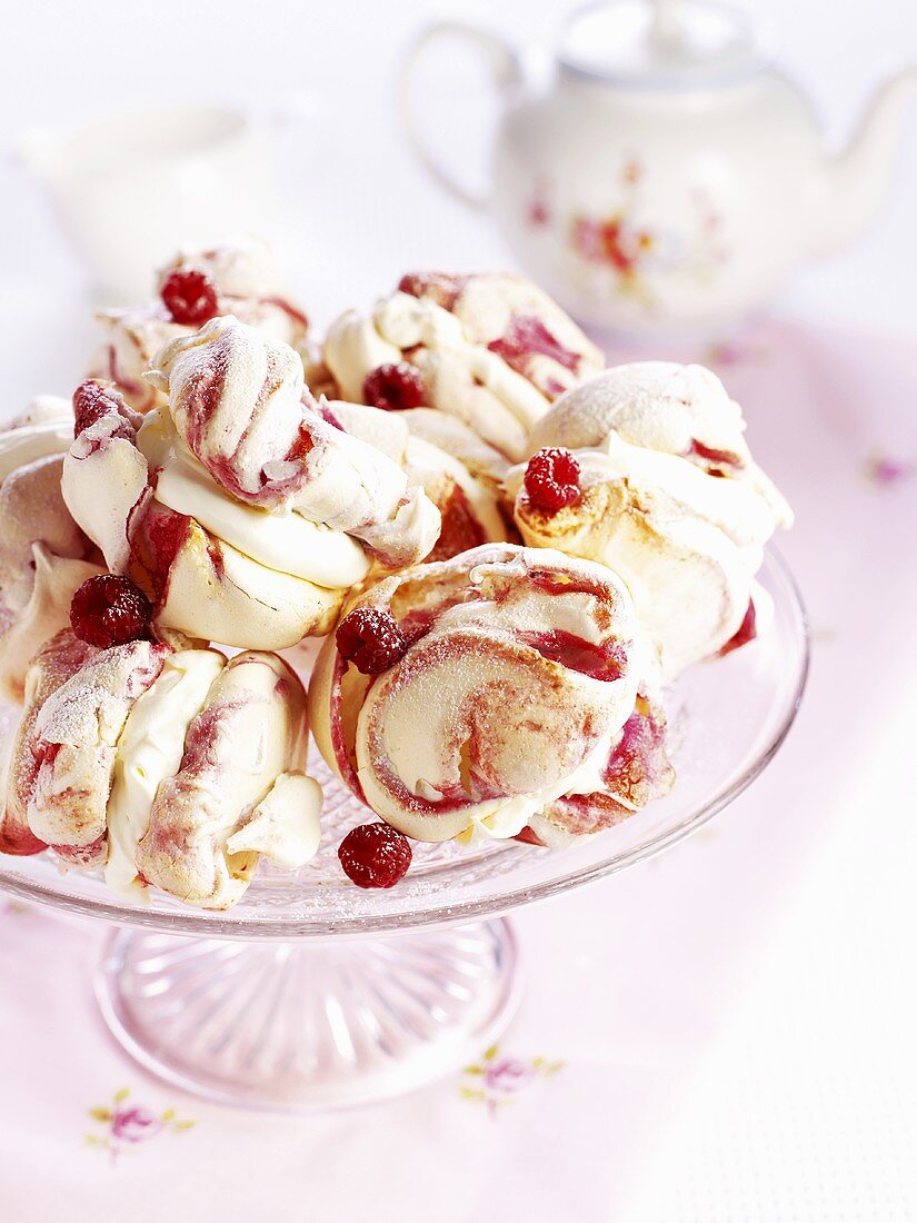 Raspberry meringues on a cake stand
