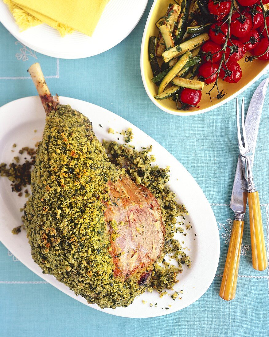 Leg of lamb in herb crust with courgettes and tomatoes