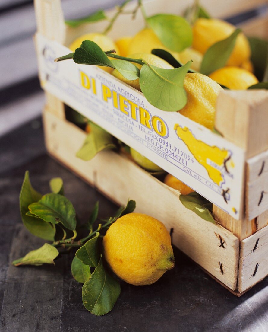 Fresh lemons in a wooden crate