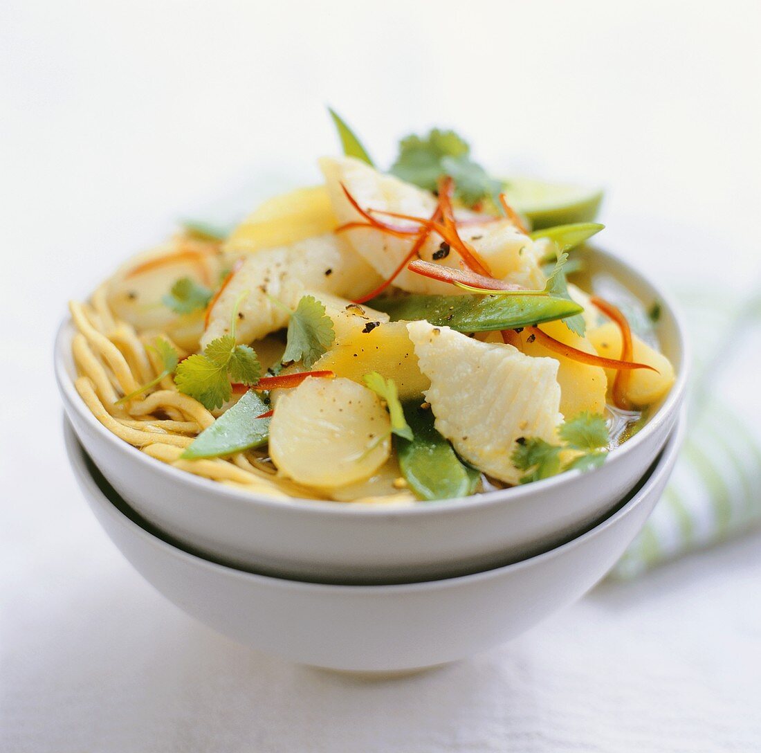 Asian noodle soup with fish and potatoes