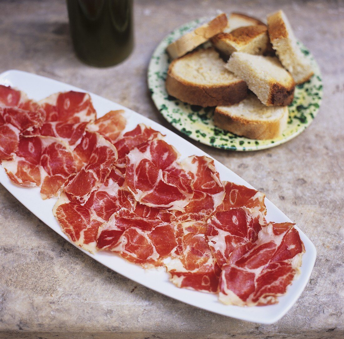 A platter of ham with white bread