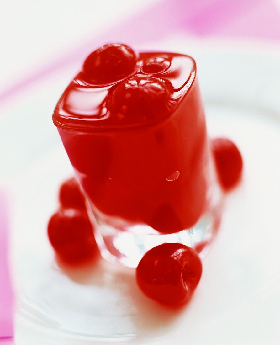 A glass of cherry liqueur with cherries