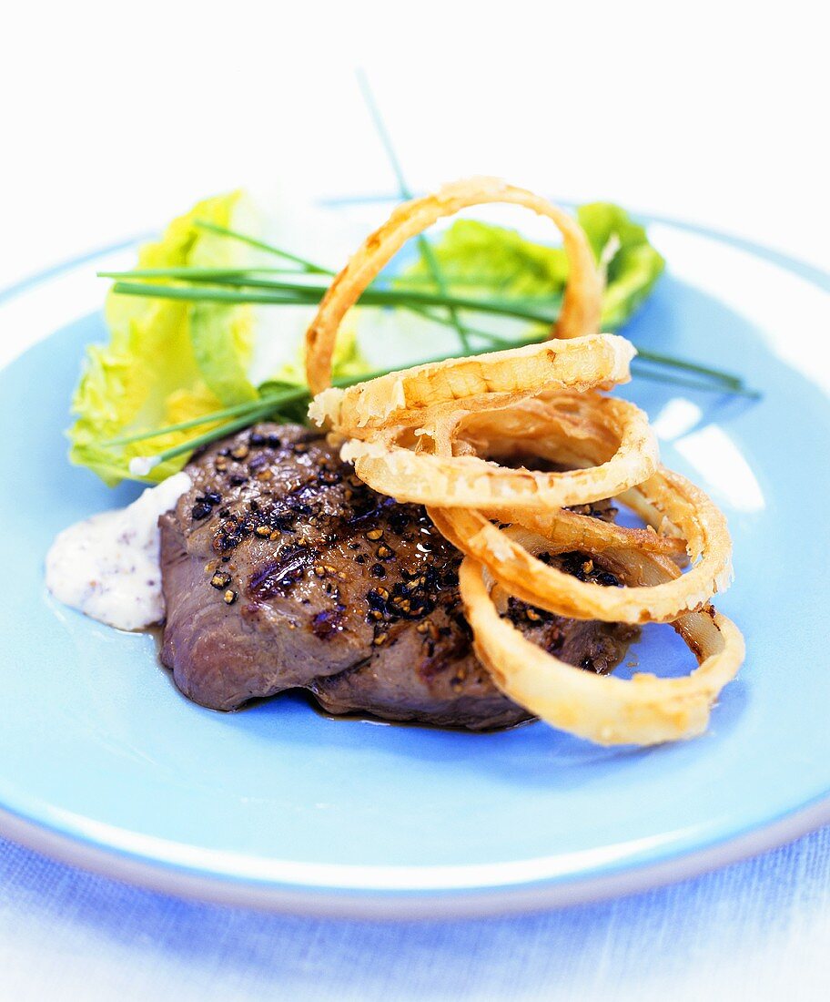 Barbecued steak with onion rings