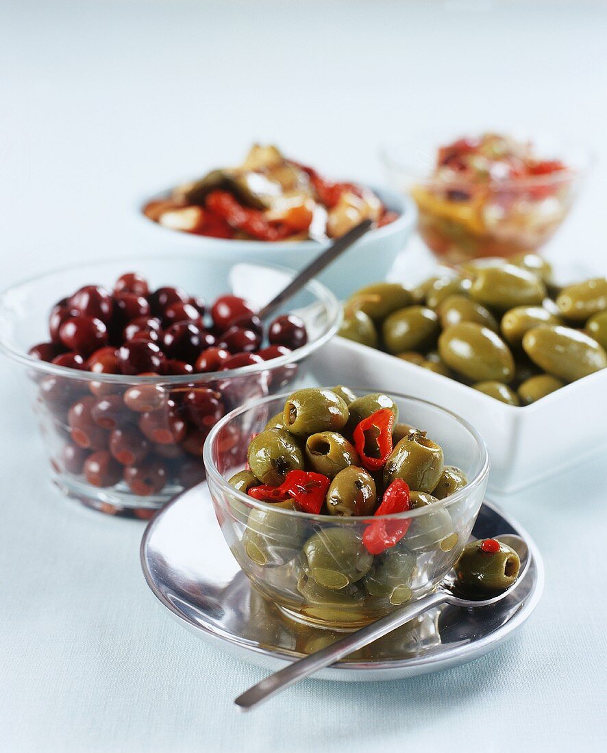 Various types of olives in dishes