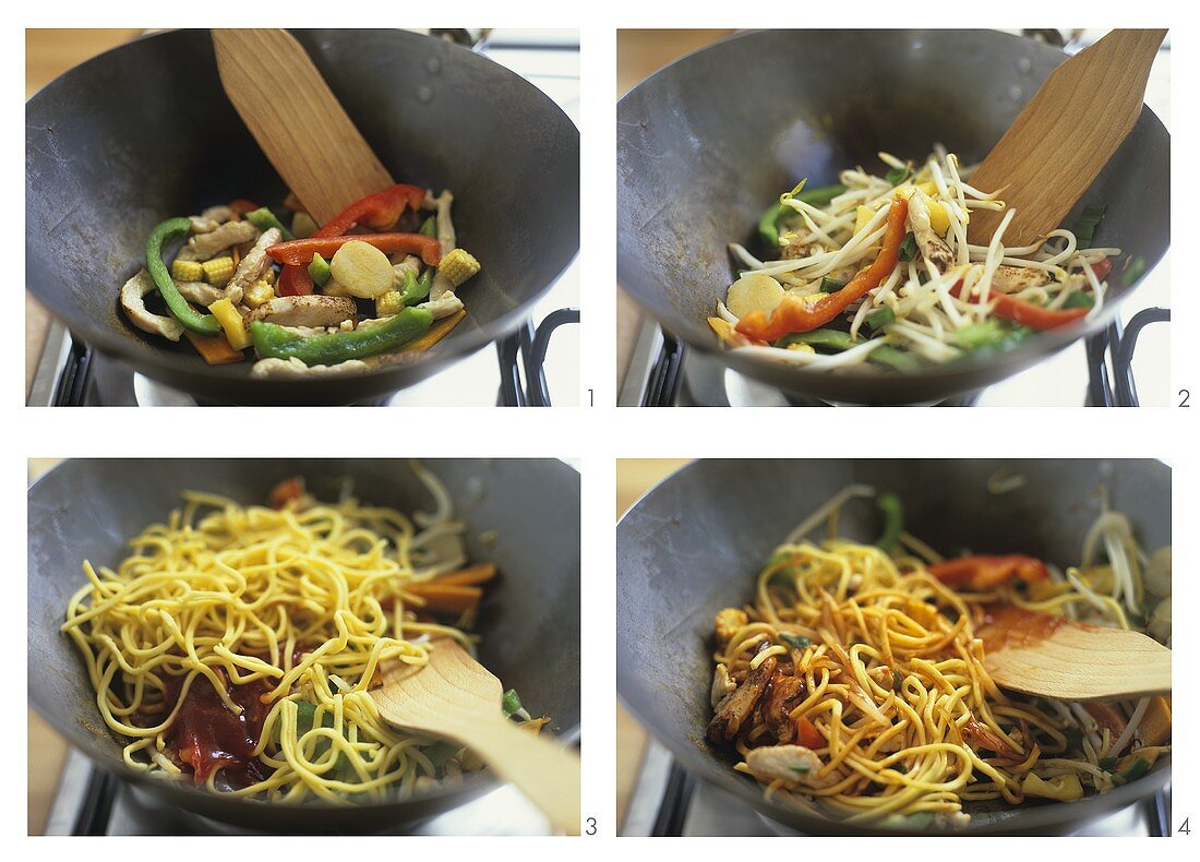 Stir-frying egg noodles with chicken and vegetables in wok