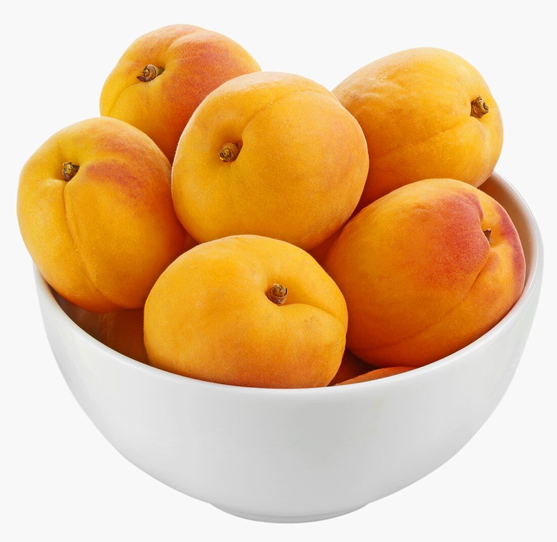 Fresh apricots in white bowl