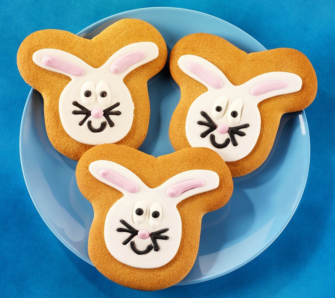 Three Easter Bunny biscuits on blue plate