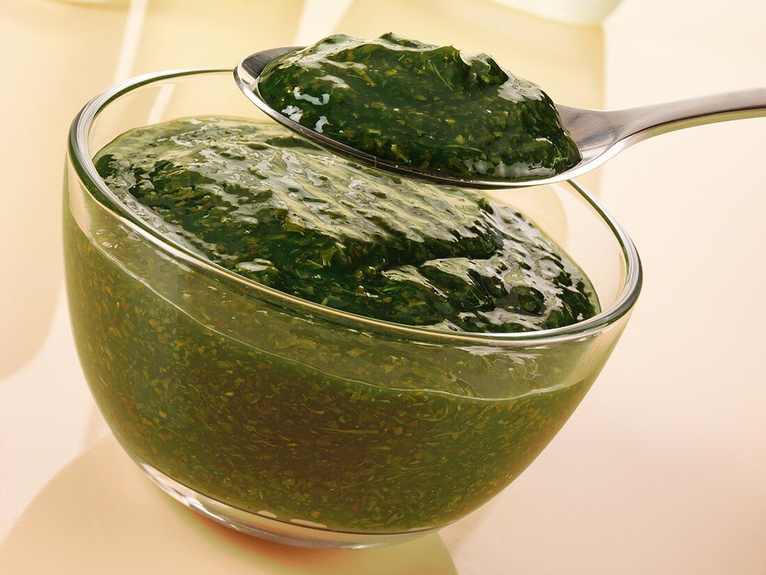 Mint sauce in glass bowl and on spoon