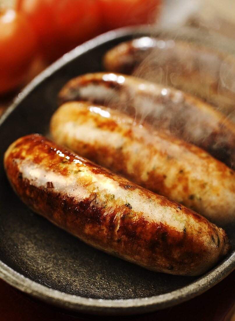 Hot sausages in a frying pan