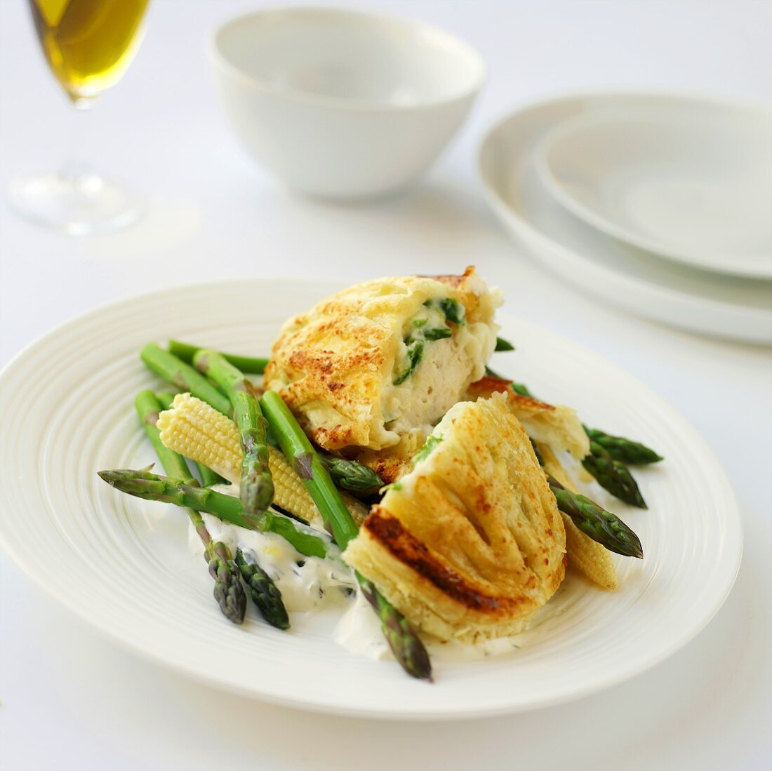 Chicken breast in pastry with asparagus and baby corn cobs