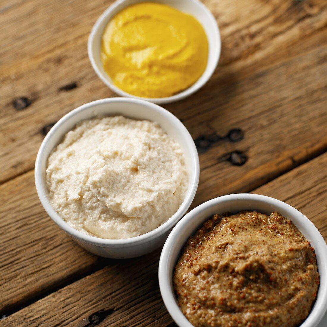 Creamed horseradish & two sorts of mustard in small dishes