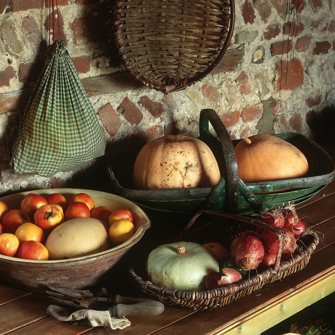 A display of pumpkins, onions and apples