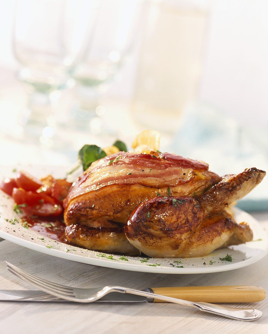 Roasted partridge wrapped in bacon with a redcurrant sauce