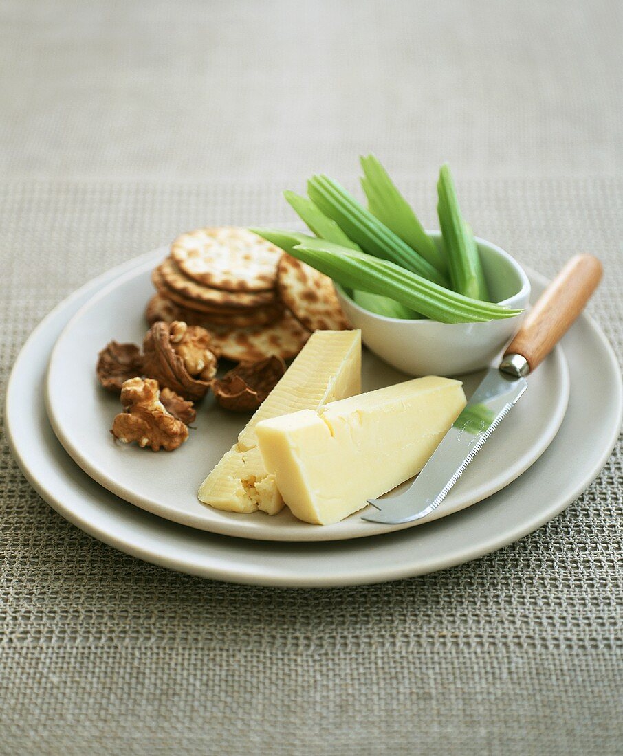Cheese with walnuts, crackers and celery
