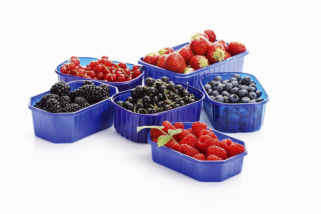 Six different types of berries in plastic containers