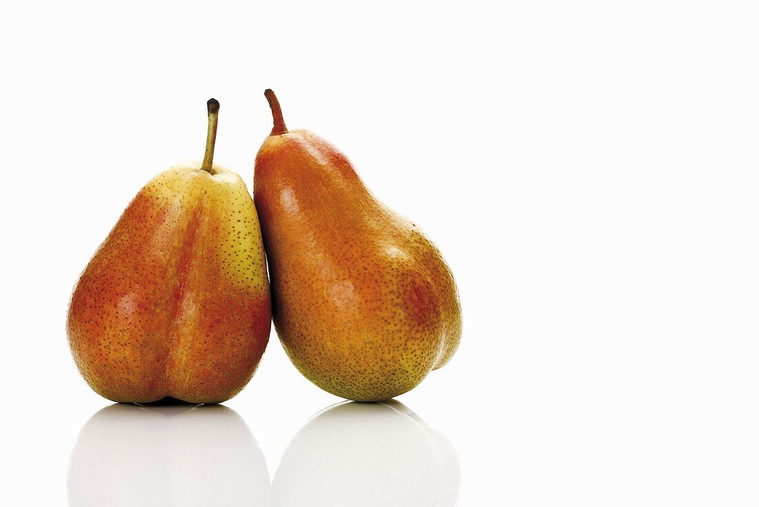 Two Forelle pears leaning against each other