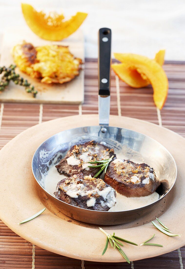 Venison medallions in a frying pan