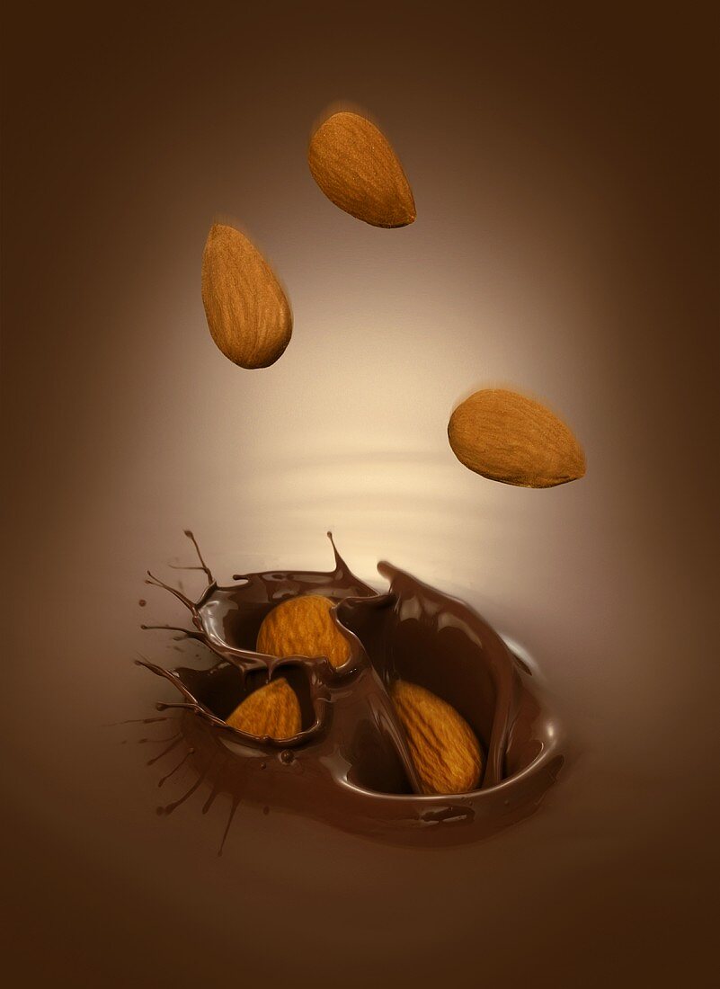 Almonds falling into chocolate sauce