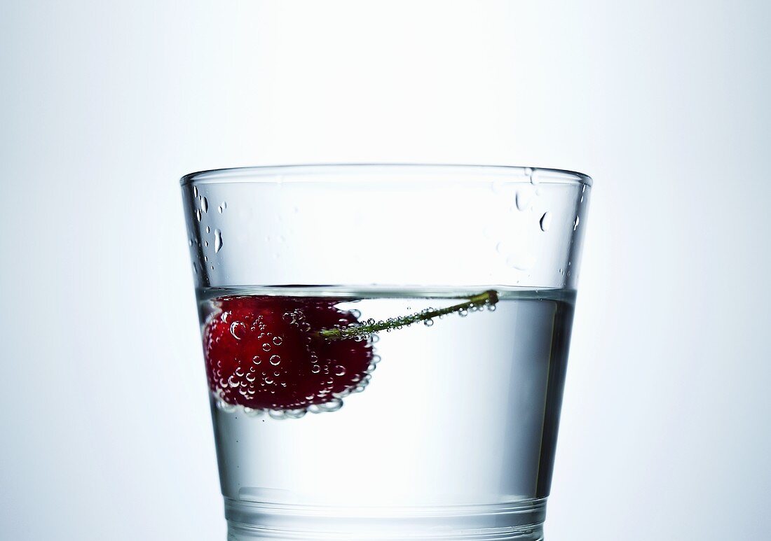 Cherry in a glass of water