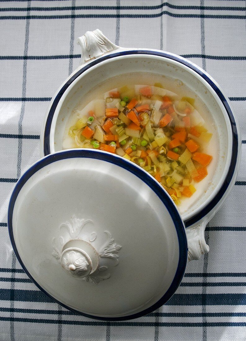 Vegetable soup with peas and leeks in a soup tureen