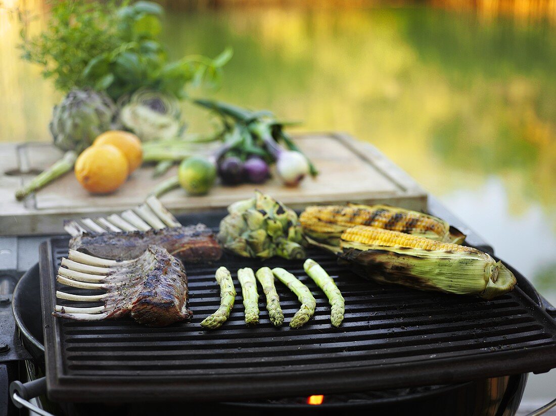Lamb chops, vegetables and corn on the cob on a barbecue