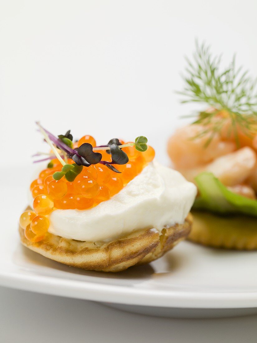 Blini with sour cream and salmon caviar