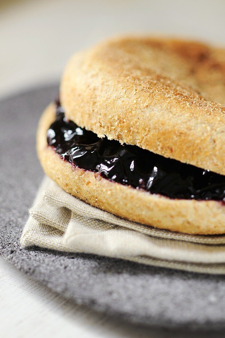Bread roll filled with blackcurrant jelly