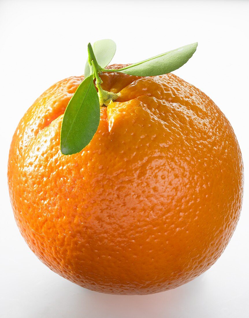 An orange with leaves