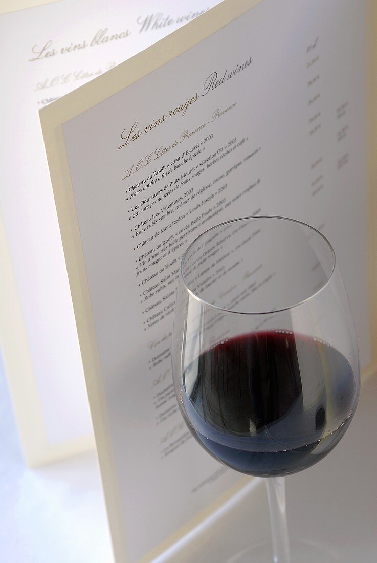 Glass of red wine and wine list (France)