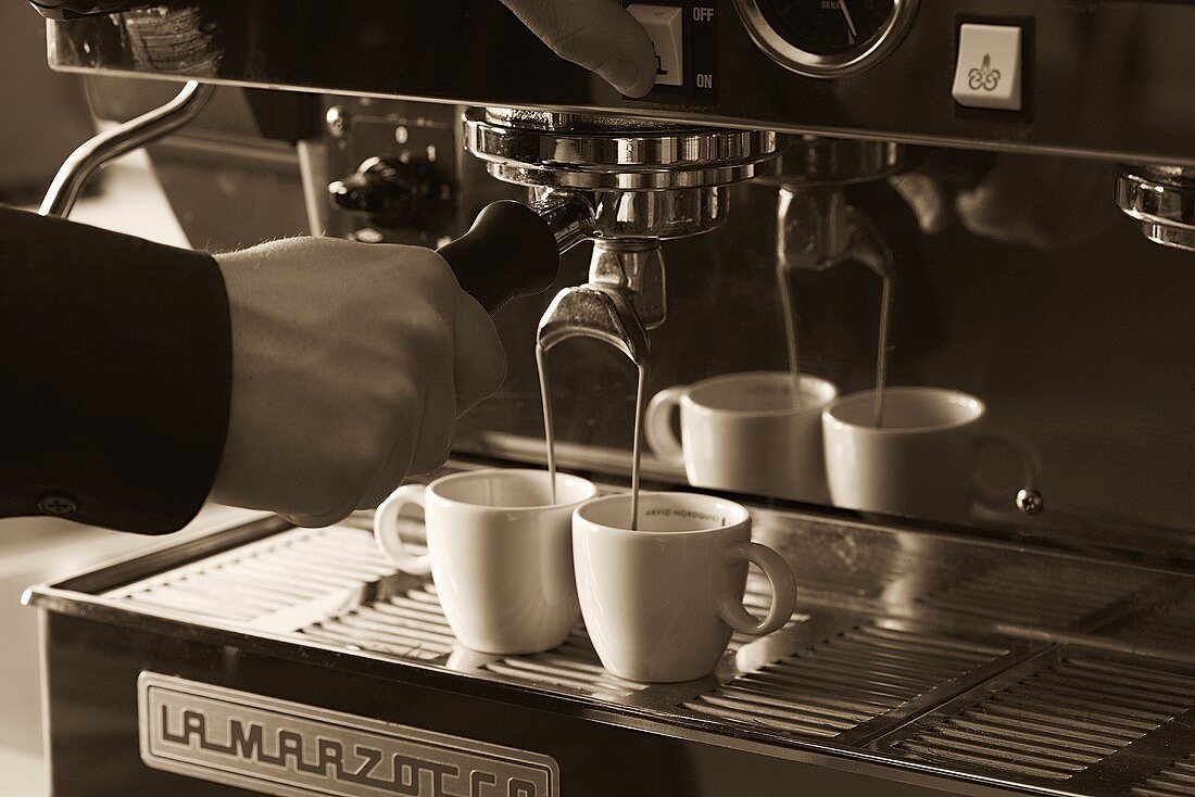 Two cups of espresso being filled