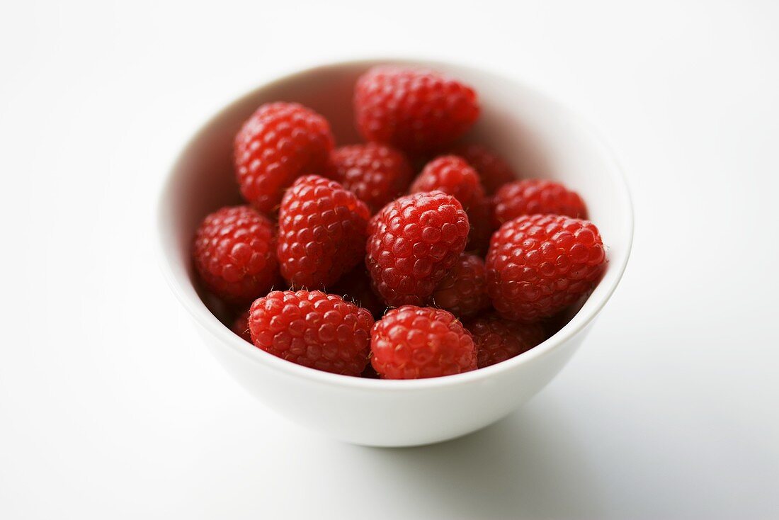 Fresh raspberries in white bowl