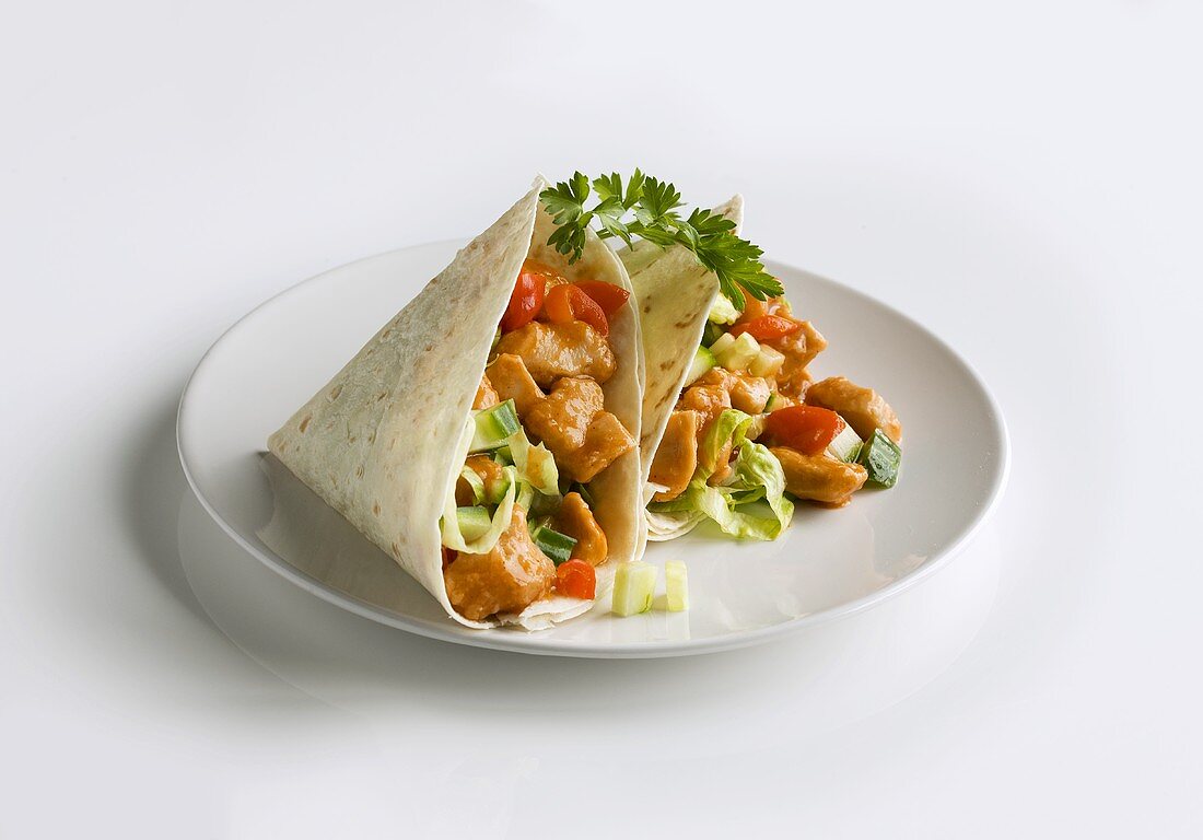 Two chicken wraps on plate