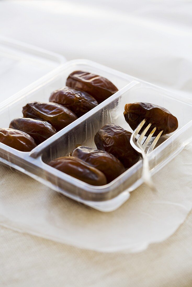 Dried dates in a plastic tray