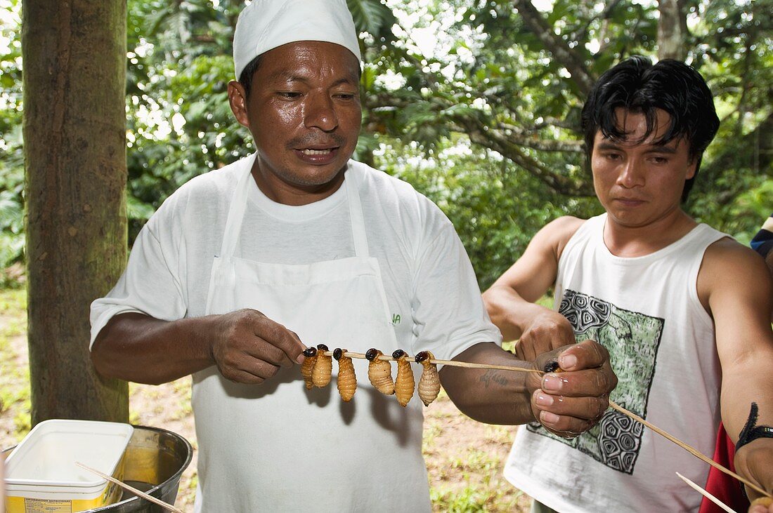 Natives of Ecuador cooking maggots